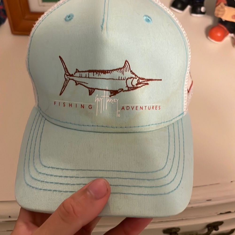very worn guy harvey fishing hat